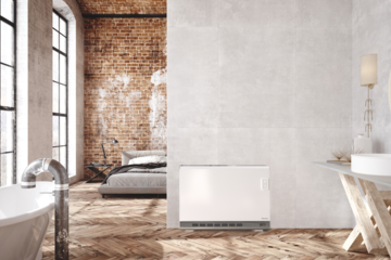 Dimplex zeigt eine offene Loftwohnung mit schönem Holzboden, Schlafbereich und Badezimmer mit einer freistehenden Badewanne mit Rohr im Industrial Look und einer weissen, eckigen Wärmepumpe an der Wand.