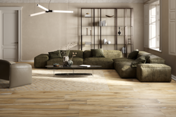 Fliesendorf zeigt ein Wohnzimmer mit gefliestem Boden in Holzoptik, einer olivgrünen Couch aus Leder, ovalem Beistelltisch und schwarzem Wandregal mit Dekoelementen.