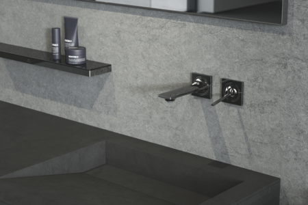 Grohe zeigt ein Badezimmer im Industrial Look mit dunkelgrauem Waschbecken und silbernen Armaturen.