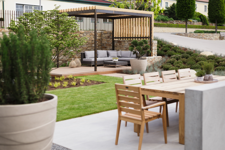 Sitzecke im Garten vor schattiger Pergola mit Rattanloungemöbeln von Nentwich Gartengestaltung.