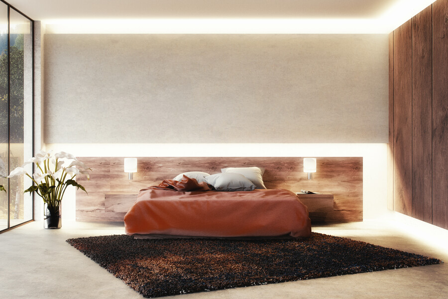 Helles, modernes Schlafzimmer mit Doppelbett und indirekter Beleuchtung und Stimmungslicht an Wänden und Boden.