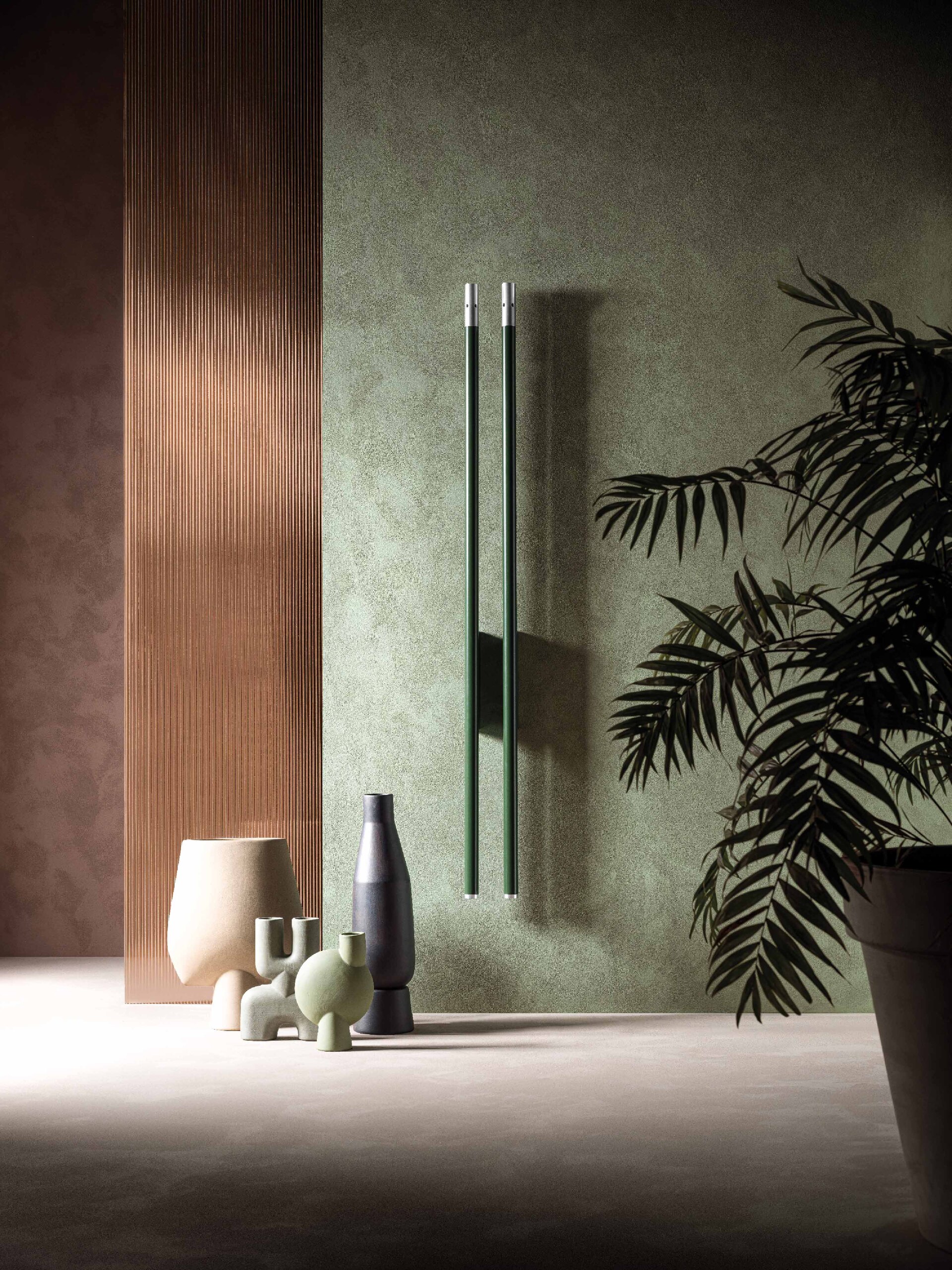 Wohnbereich mit 2 wandmontierten senkrechten Handtuchwärmern "Carlo & Tina" im Röhren-look in silber und grün von ANTRAX IT.