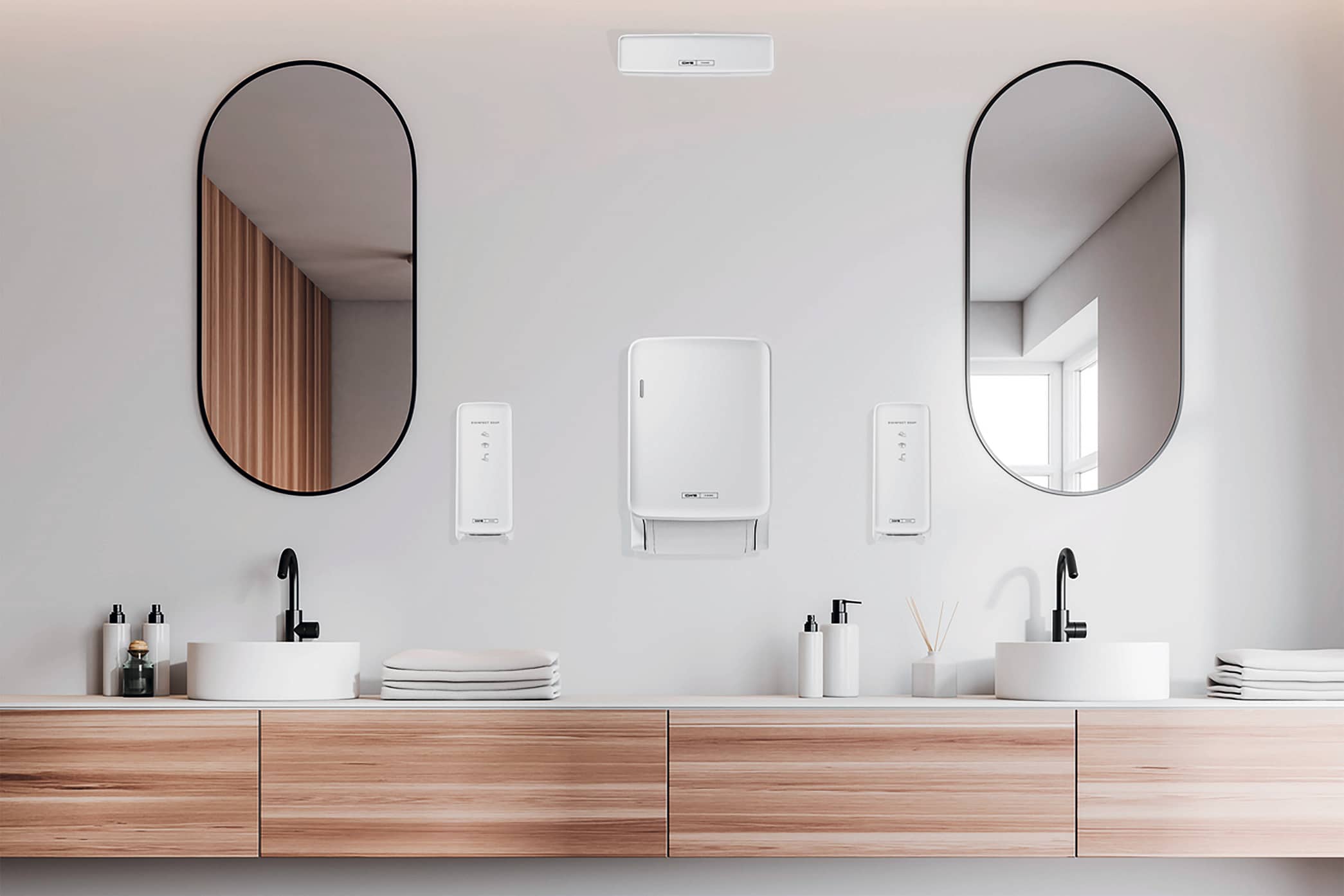 CWS Hygiene zeigt ein modernes Badezimmer mit Doppelwaschtisch und an der Wand montierte Handtuchspender und Seifenspender in weiß.