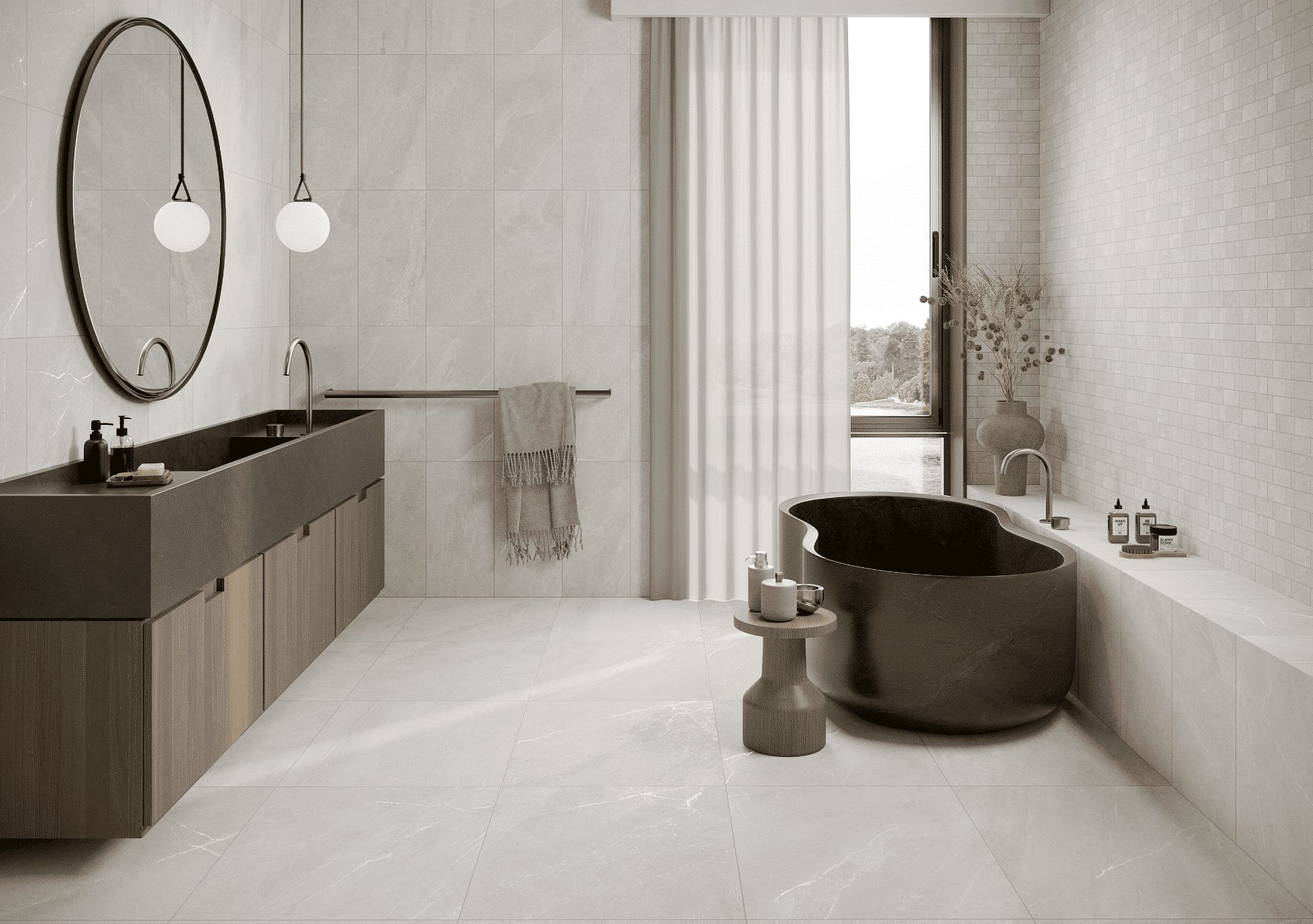 Fliesendorf zeigt ein hellgrau gefliestes Badezimmer mit einem Waschtisch aus Holz und einer freistehenden Badewanne in der Form einer Acht und mit silbernen Armaturen.