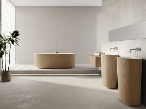 Fliesendorf zeigt elegantes Badezimmer mit freistehendem, hellbraunen Waschbecken und Badewanne mit gerillter Oberfläche.