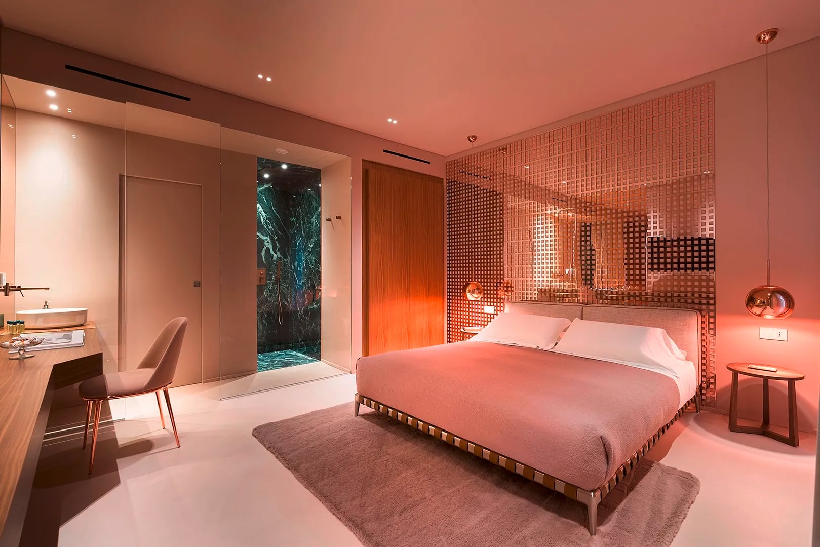 Gessi zeigt ein Schlafzimmer mit angeschlossenem Badezimmer mit Armaturen aus der Serie Rettangolo K in den Taormina Infinity Suites.