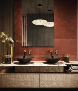 GESSI zeigt einen Doppelwaschtisch mit Marmorplatte und freistehenden schwarzen Waschbecken und goldfarbenen Armaturen an der Wand montiert.