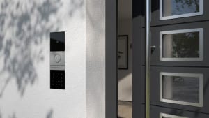 Türöffner mit Kamera und Zahlentasten in schwarz und Metall von GIRA flächenbündig in die Außenfassade eingebaut.