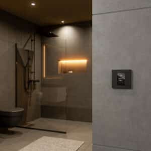 Ein Gira Schalter TS4 55 Plus 4F mit Anzeigendisplay in Anthrazit bzw. Schwarz an einer grauen Betonwand in einem modernen minimalistischen Bad im Industrial-Look.