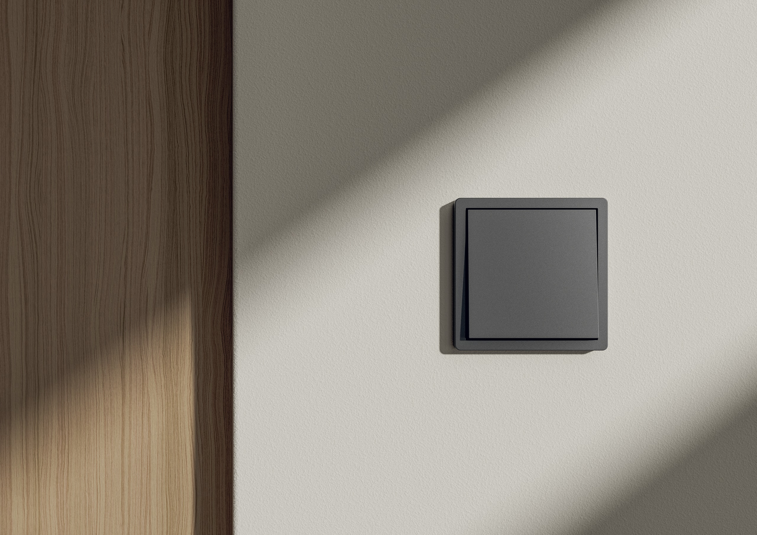 Ein schwarzer bzw. anthrazitfarbener 1-facher F100 Gira-Wippschalter mit schlankem Rahmen, modern, elegant und minimalistisch - ISOcoatedV2.