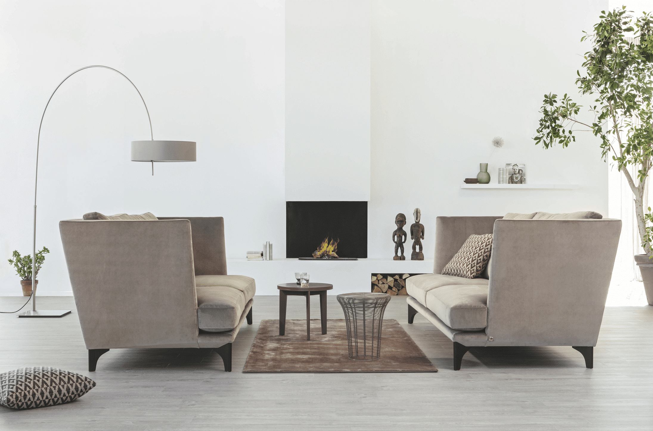 Grill & Ronacher zeigt eine sehr klassische Sitzgruppe inmitten eines Raums mit elektrischem Ofen und generell sehr heller Einrichtung von Bielefelder Werkstätten.