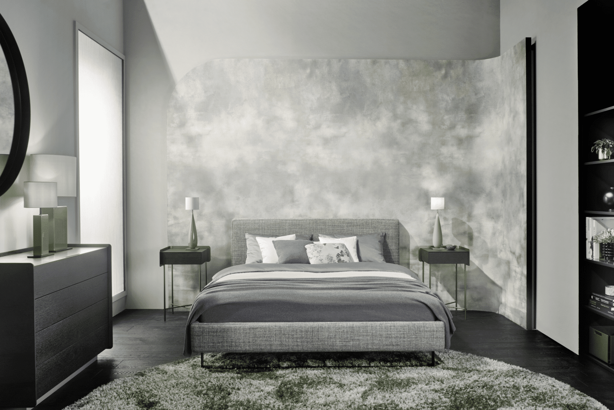 Schlafzimmer mit grauem Polsterbett, schwarzem Mobiliar und grünen Wohnakzenten von Christine Kroencke Interior Design präsentiert von Grill & Ronacher.
