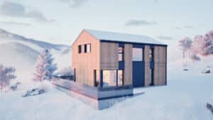 Ein Satteldach‑Haus mit einer Fassade aus Holzelementen und mattschwarzer Verkleidung, Eckverglasung, Terrassenschiebetür und Terrassengeländer aus Rauchglas in winterlicher Landschaft von HARTL HAUS.