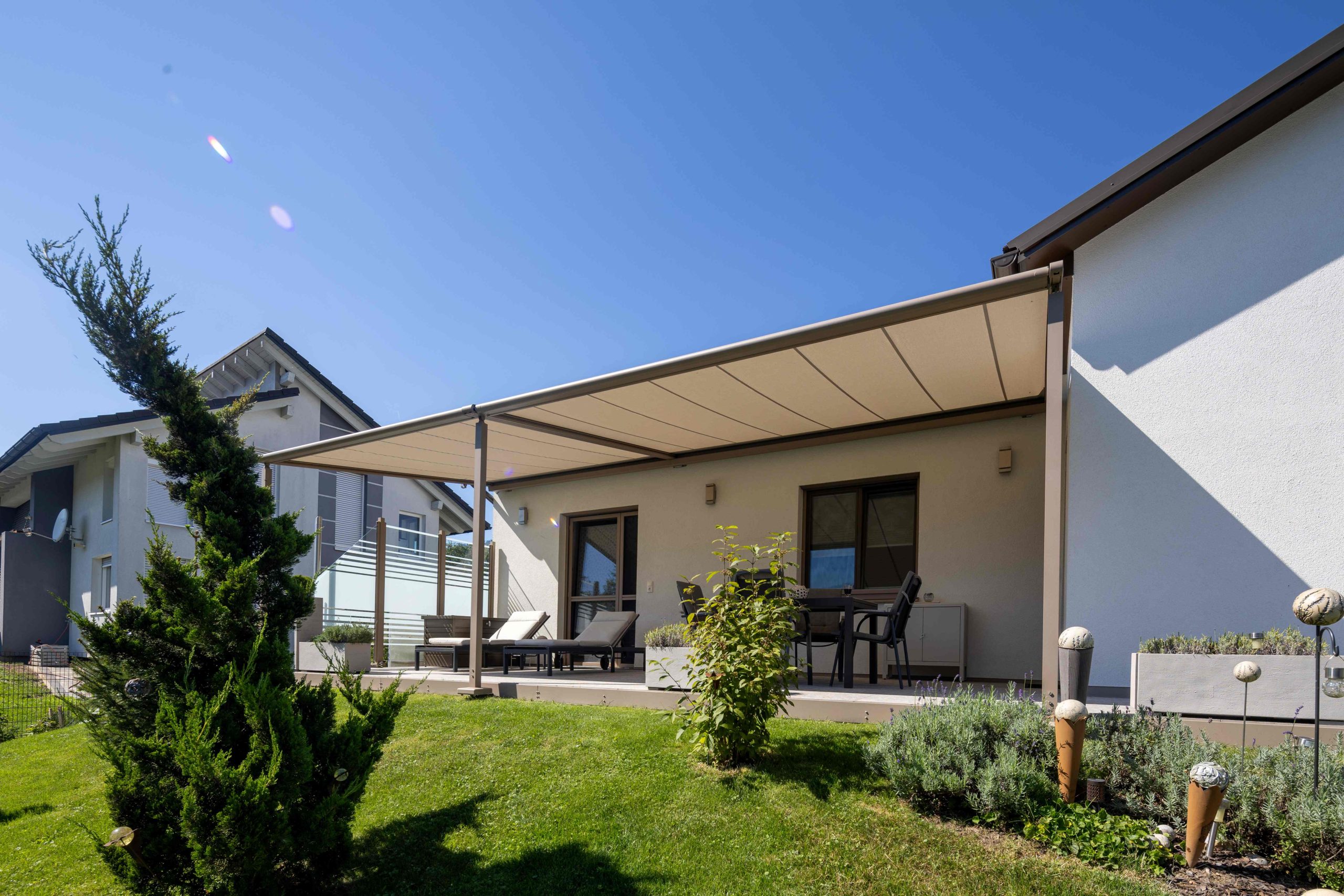 Terrasse mit ausgefahrener Markilux Cubic Pergolamarkise mit Funkmotor gezeigt von HELLSAN.