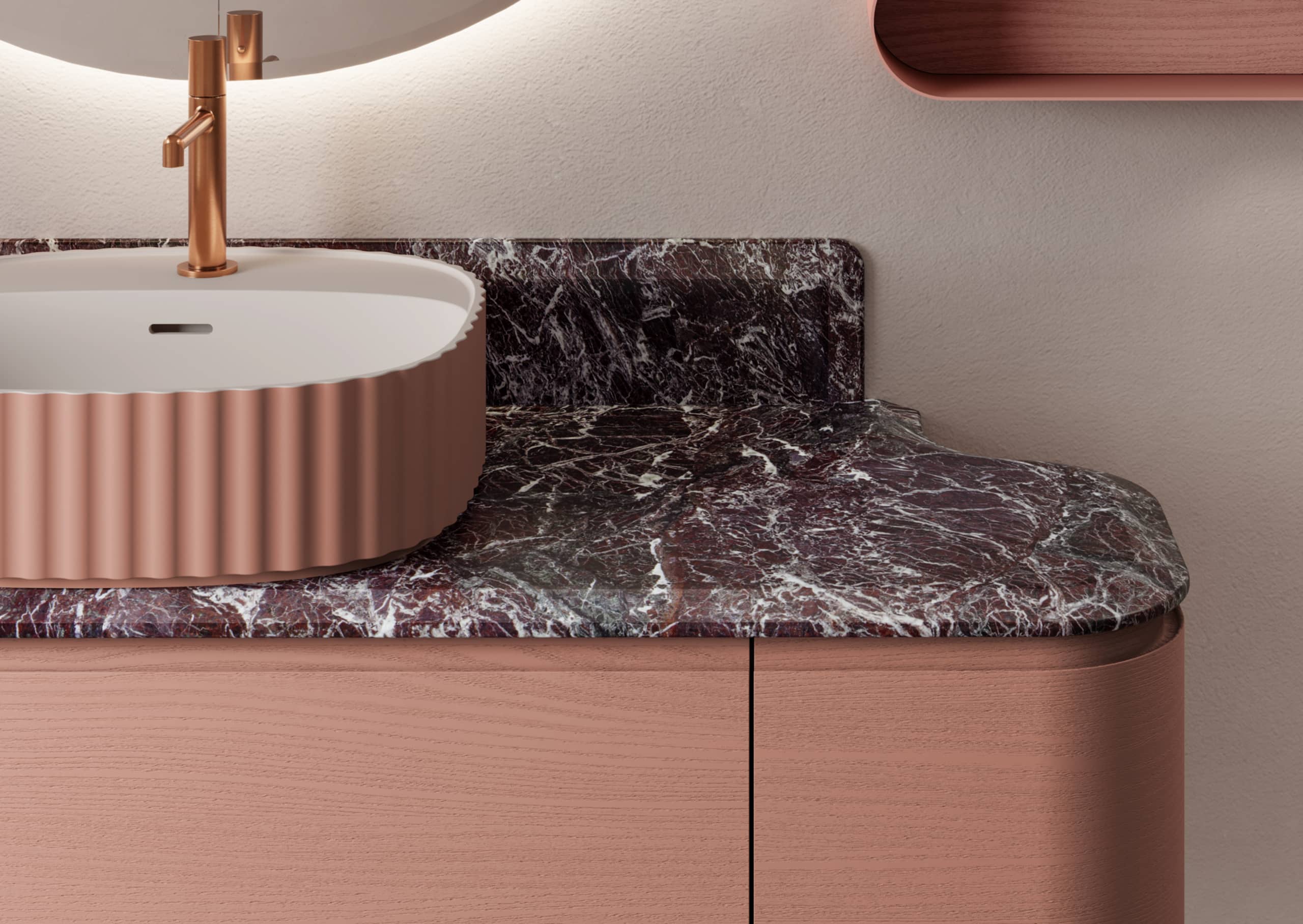 Ideagroup präsentiert einen eleganten Waschtisch mit Mamorplatte und rötlichem Holz-Unterschrank mit abgerundeten Kanten und kupferfarbenem Wasserhahn.