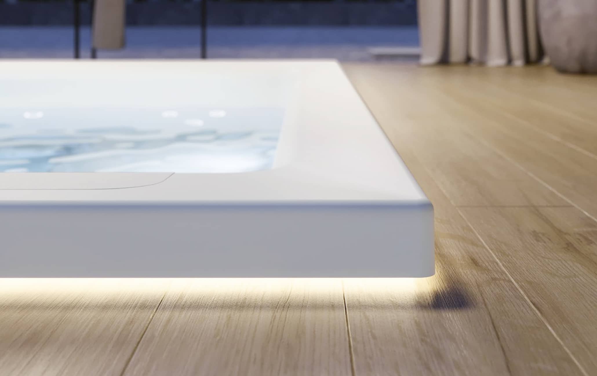 Der rechteckige Whirlpool "Helba 210" in der Unterbau-Version mit Unterwasser-Beleuchtung, Hydromassage-Düsen und LED-Randbeleuchtung von Disenia.