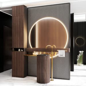 Badezimmer mit raumtrennender Wand mit großem beleuchteten Rundspiegel und hohem Badezimmerschrank, Ablageboard mit Handtuchhalter, holzverkleideter Waschsäule und einer freistehenden hohen Waschtischarmatur, goldmattiert mit Metallgriffen von Jörger.