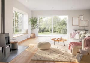 Ein offener Wohnraum mit Couch, Kamin, grosser weißer Kunststoff/Aluminium-Terrassenschiebetür so wie Sitzfenster mit Sprossen aus der Zirkon‑Reihe von Josko.