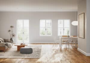 Ein romantisch-rustikaler offener Wohn‑ und Essbereich mit Terrassentür und Fenstern aus der Reihe "Zirkon" in weißem Kunststoff/Aluminium mit schwarzen Griffen von Josko.