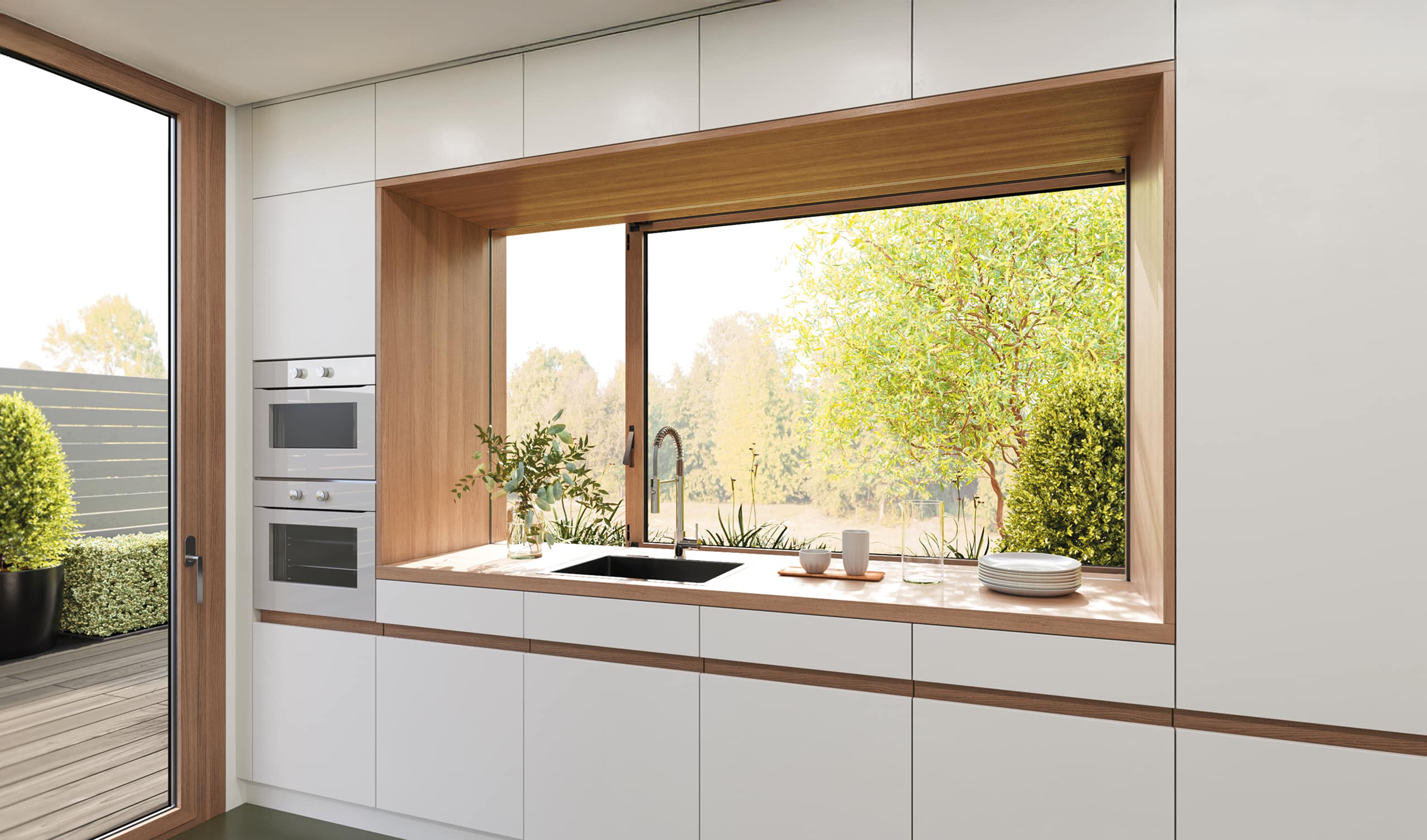 KDM Innovation zeigt eine Küche mit einem Fenster, das quer zur Arbeitsfläche verläuft und Dank Movista Fensterbeschlägen per Schieben geöffnet werden kann.