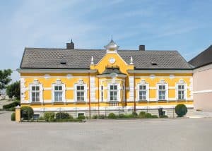Klassische sanierte Villa mit Zwerchdach, Erker und Stuckfassade in Gelb und Weiß von Kickinger Bau.