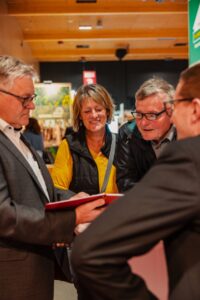 Besucherinnen und Besucher im Beratungsgespräch mit Ausstellern über aktuelle Angebote und individuelle Lösungen rund um Bauen, Energie und Wohnen auf der Messe in Wieselburg.