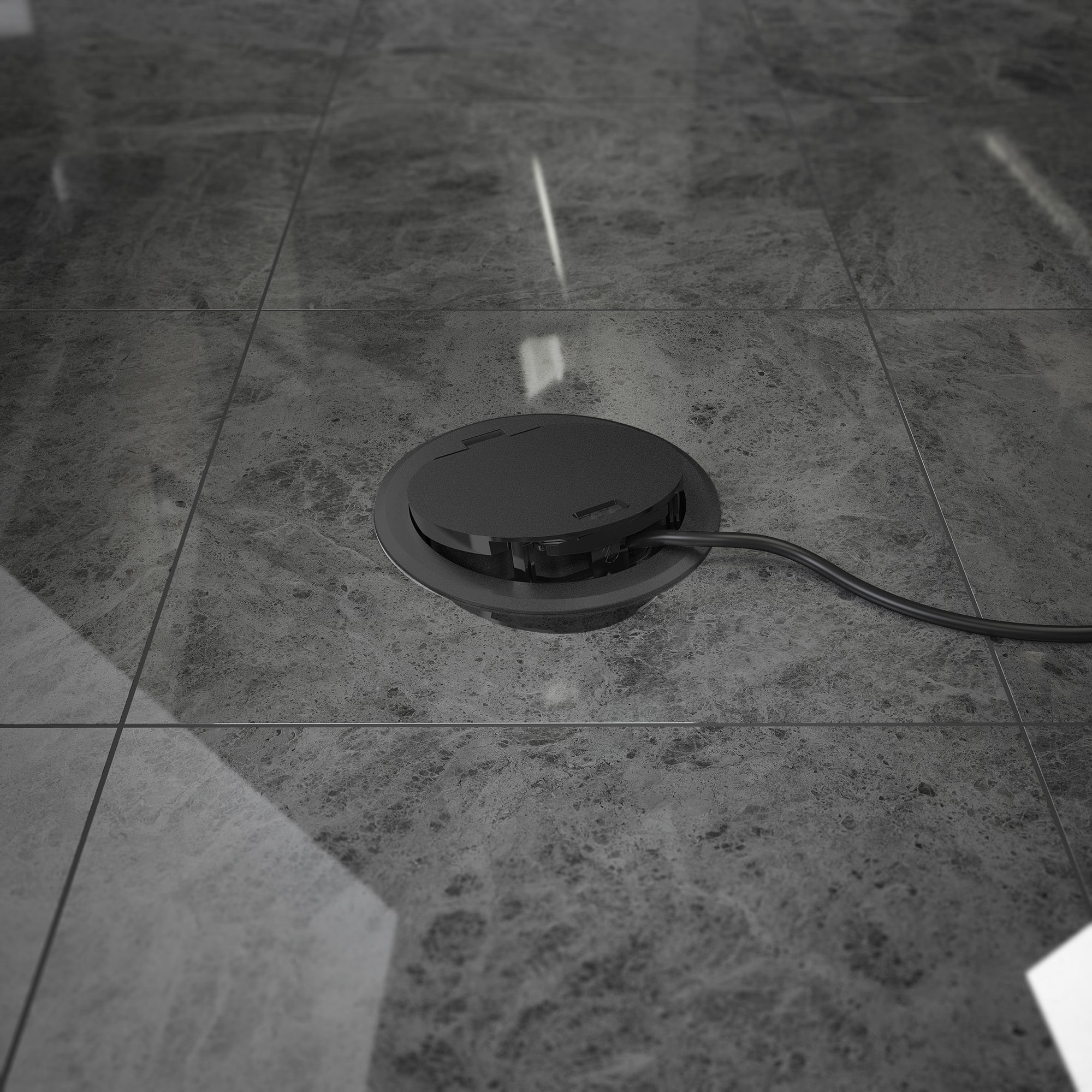 OBO Bettermann zeigt einen schwarzen Geräteeinsatz mit Klappdeckel im Fliesenboden in dem ein Kabel angeschlossen ist.