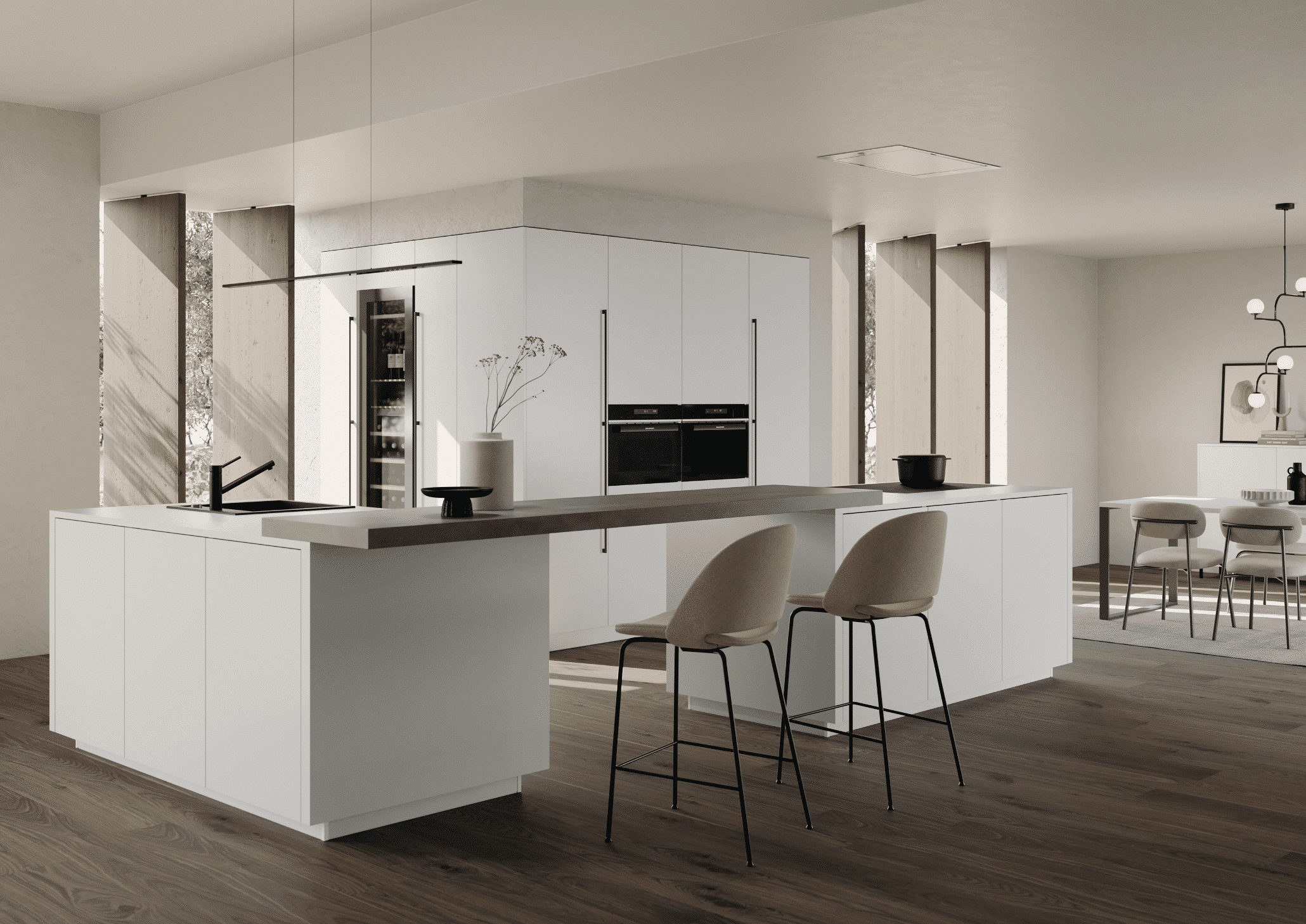 Bauer Tischlerei zeigt eine offene Küche mit weisser Kücheninsel aus zwei Küchenblöcken die mit einer Bar verbunden sind und einem schwarzen Spülbecken und Einbauschrank in weiss mit integrierten Geräten von Häcker Küchen.