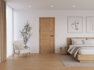 Schlafzimmer in Naturtönen, Parkettboden, einem Bettrahmen aus Vollholz, 2 Wandgemälden, einem Weidekorb, einem niedrigen Polstersessel, einer Zimmerpflanze und einer Innentüre aus Holz mit passender Zarge und einfacher mattschwarzer Klinke von WIENTÜR91.