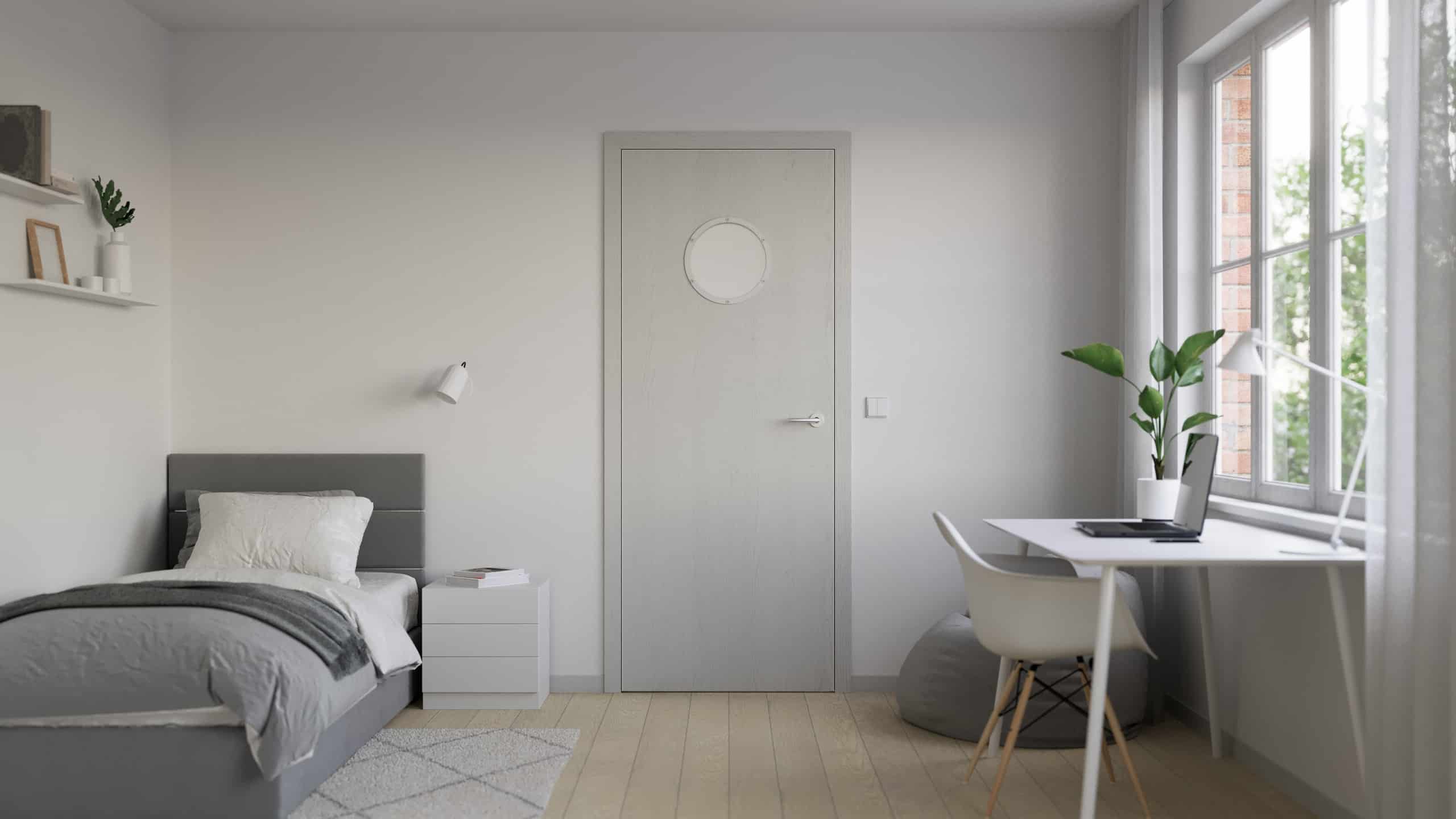 Ein modernes Innentürblatt des Modells METRIC in heller Oberfläche, gestaltet für ein Jugend- oder Kinderzimmer und ausgestattet mit einem runden Bullaugen-Fenster mit silbernem Metallrahmen, das einen spielerisch-maritimen Akzent setzt und Licht zwischen den Räumen durchlässt, von WIENTÜR91.