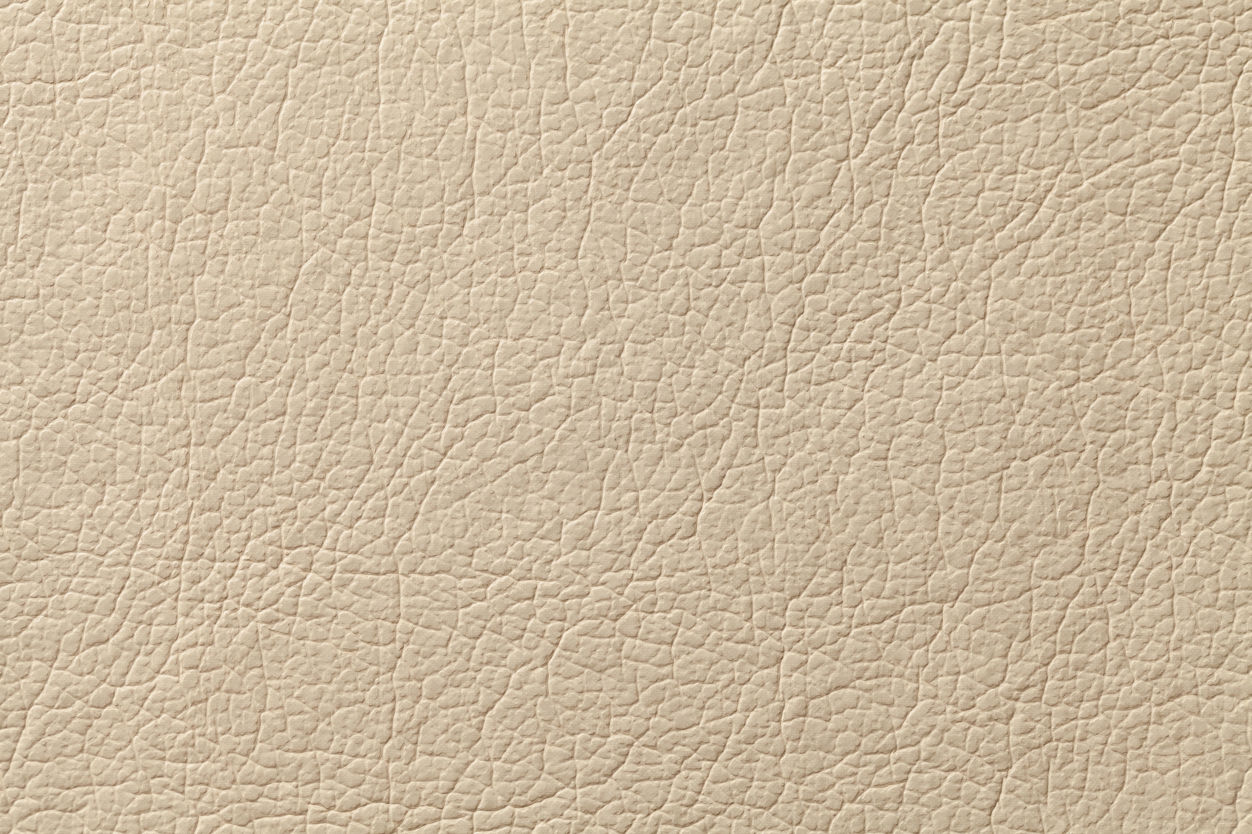 Textur einer beige farbigen Lederoberfläche.