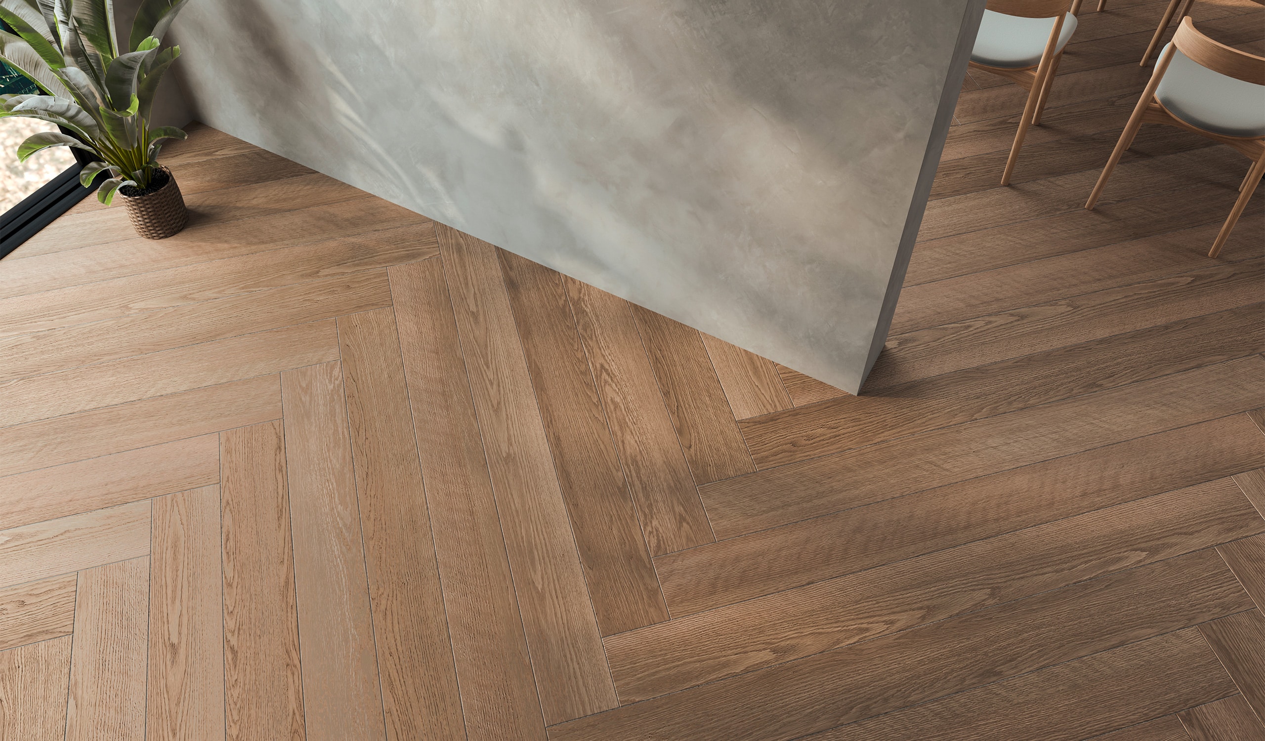Draufsicht auf modernes Interieur einer Wohnung, Küche, Esszimmer mit Tisch und Stühlen, leeres Wohnzimmer mit Betonwand und hochwertigem Parkettboden aus Massivholz in Fischgrätverlegung.