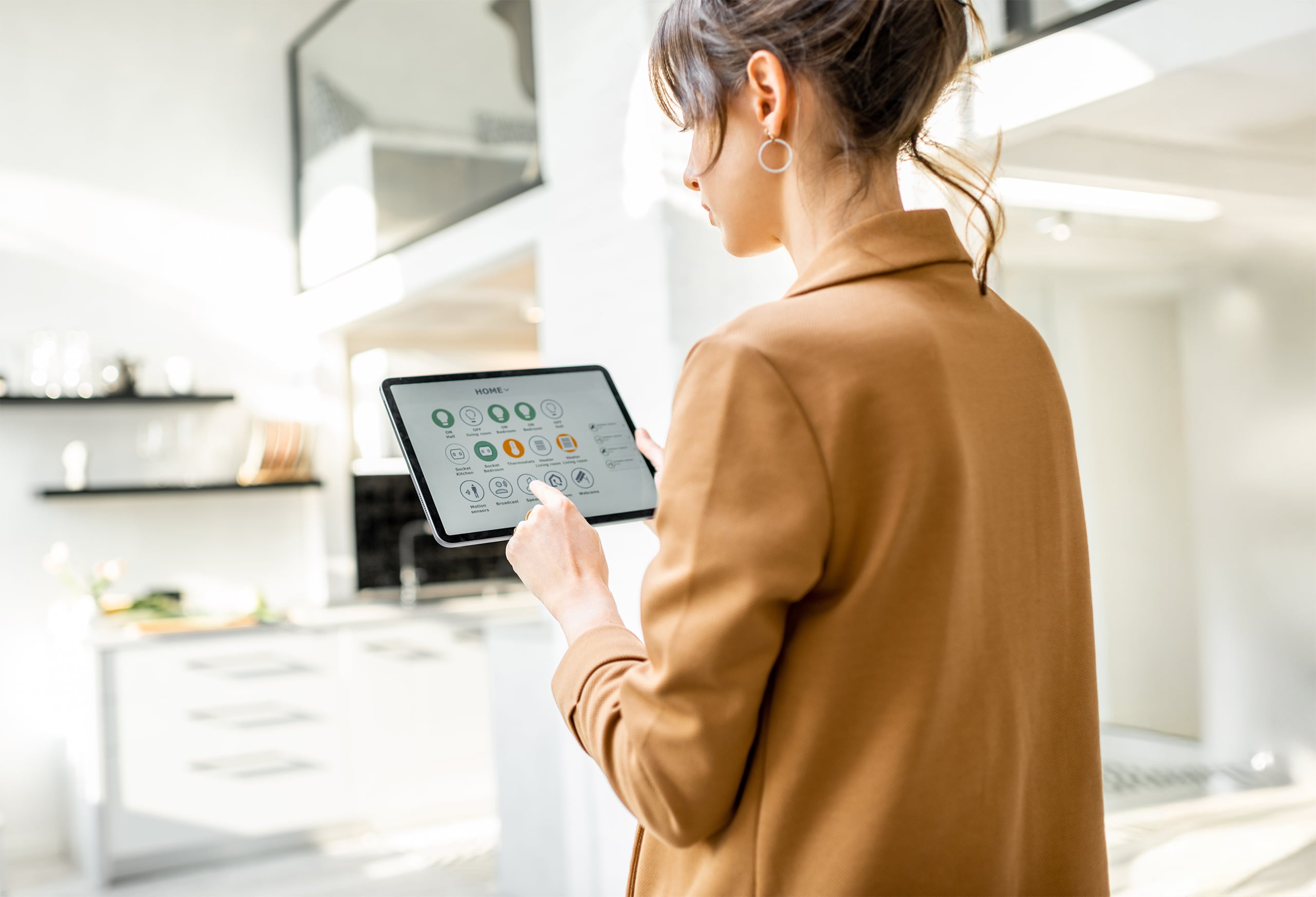 Junge Frau klickt am Tablet Einstellungen für Smart Home-Anwendungen.